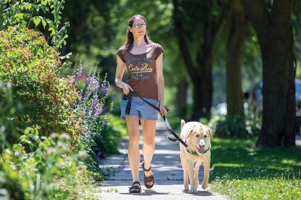 Carmen Nightfall walking her dog on a sunny summer day.