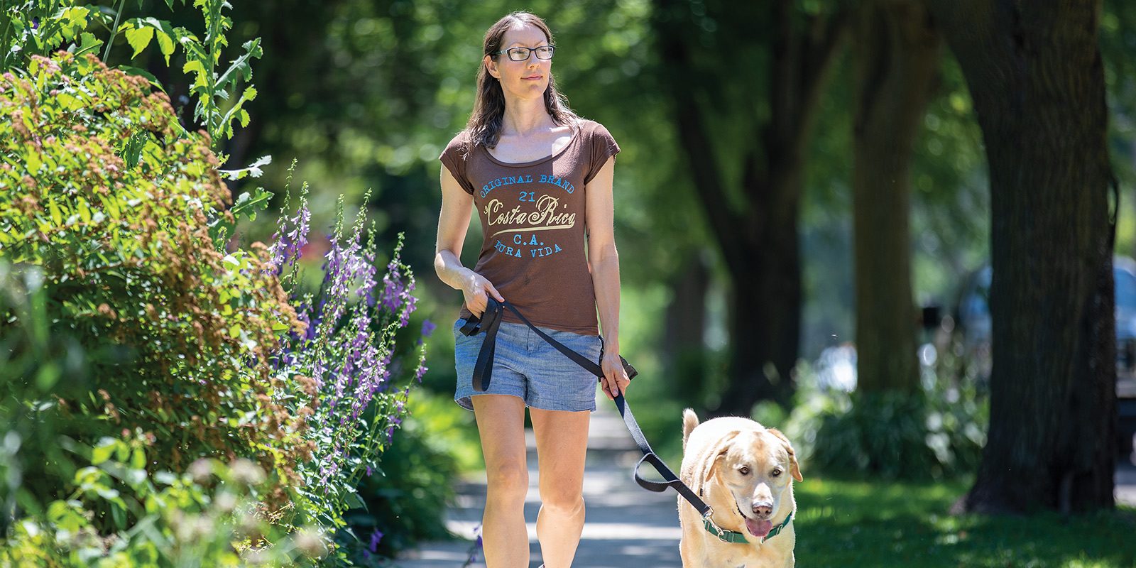 Carmen Nightfall walking her dog on a sunny summer day.